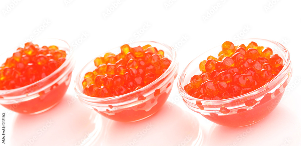 Red caviar in glass bowls isolated on white Red caviar in glass bowls isolated on white