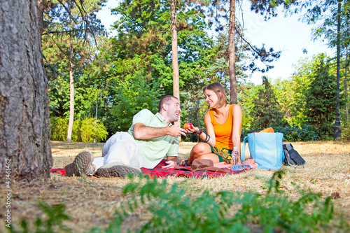 Beautiful young man and woman on picnic in forest