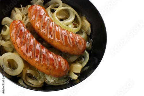 Frying pan with sausage and onion