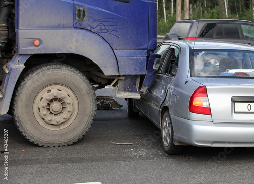 collision of the truck and car on a busy road photo