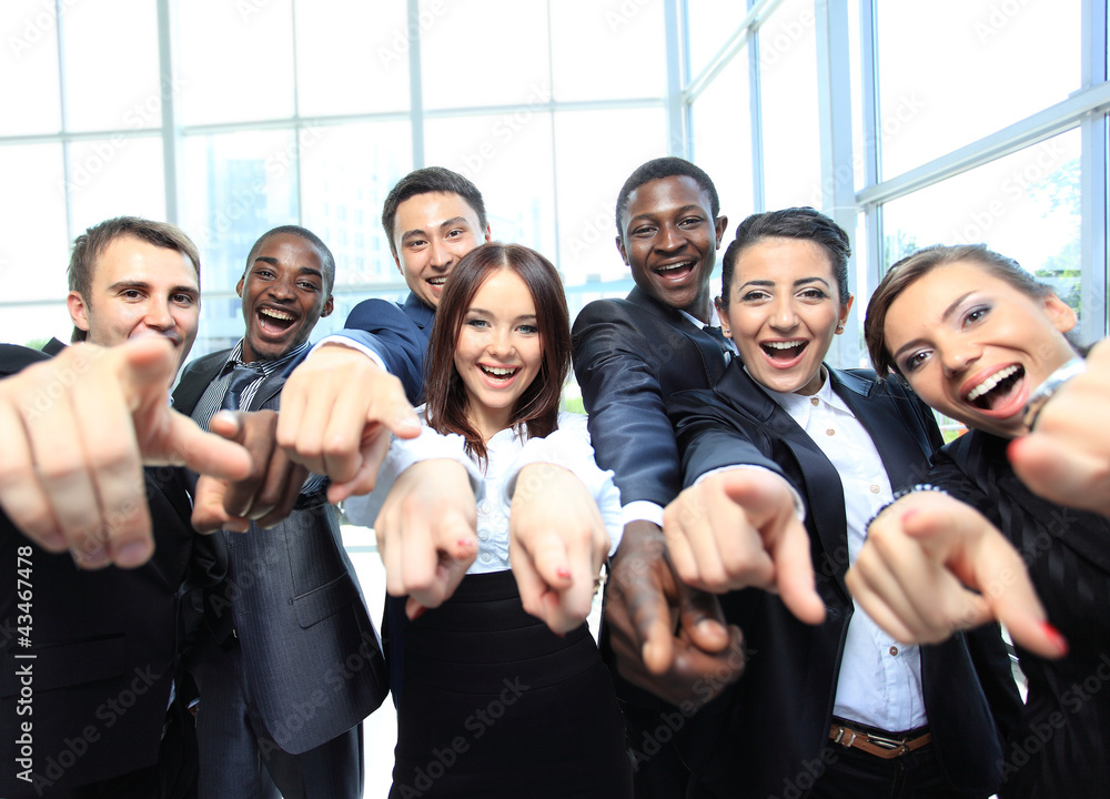 Obraz premium Portrait of excited young business people pointing