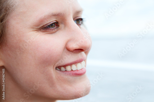 Close up of beautiful woman face in profile with sweet smile