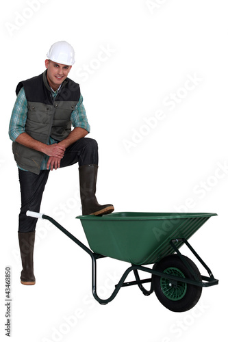 Fotótapéta Construction worker with empty wheelbarrow