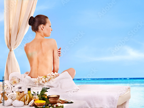 Woman getting spa lastone therapy outdoor.