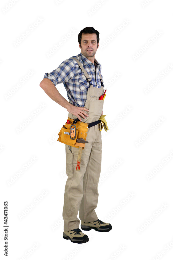 Casual male carpenter stood with hands on hips Casual male carpenter stood with hands on hips