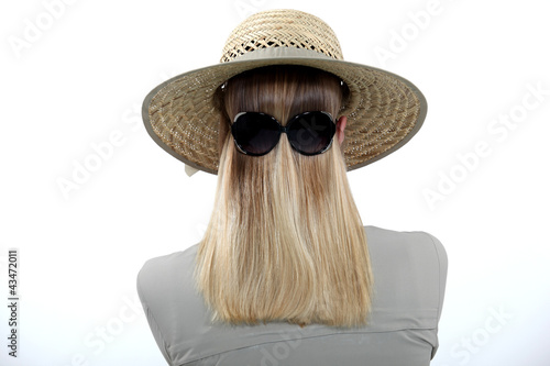 Woman wearing sunglasses backwards photo
