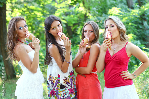 Four beautiful friends with ice-cream