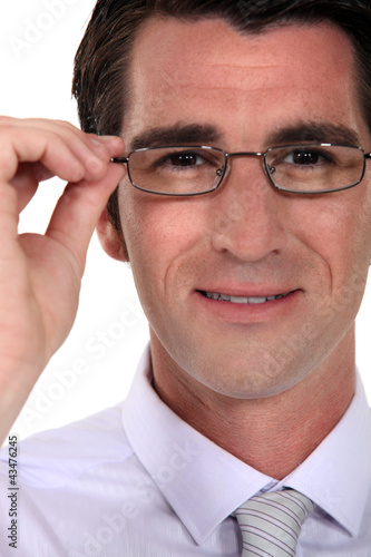 Man adjusting his glasses.