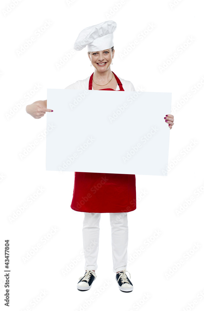 Experienced cook indicating at white banner Experienced cook indicating at white banner