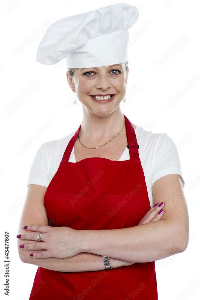 Smiling female cook with crossed arms Smiling female cook with crossed arms