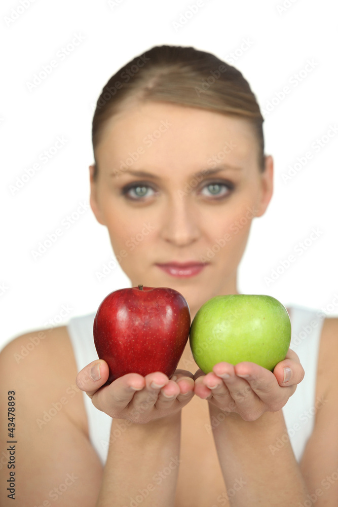 Blurry woman showing apples on white background Blurry woman showing apples on white background