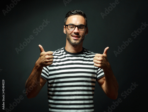 man smiling and giving you two thumbs up