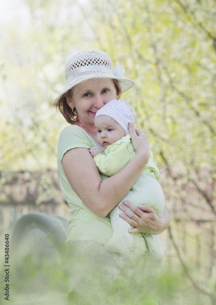 Portrait of grandmother with baby girl at spring