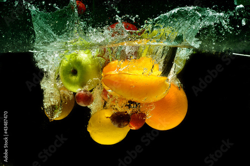 Fruit and vegetables splash into water