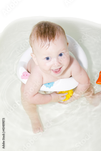 blue-eyed Baby swimming in the bath