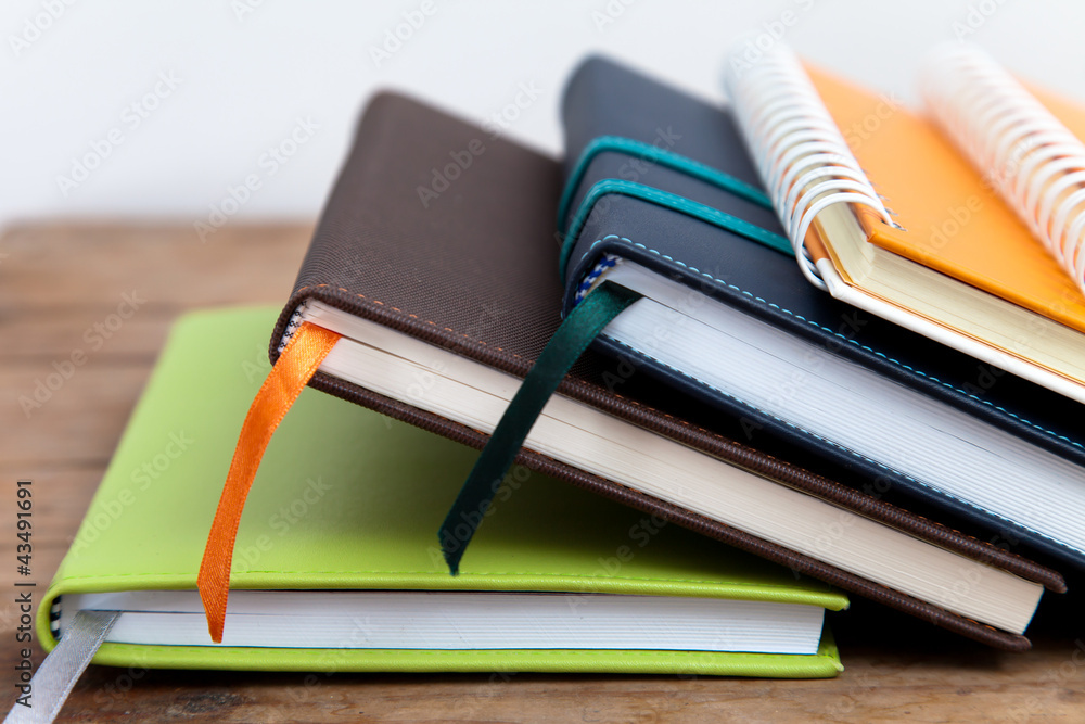 Naklejka premium notebook stack on wood background