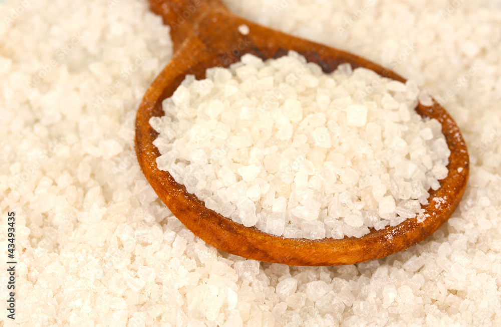 Sea salt with wooden spoon close-up
