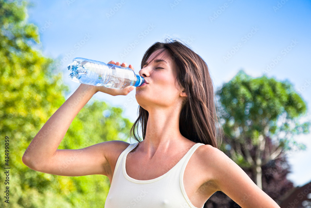 Young beautiful dark-haired woman drinking water Young beautiful dark-haired woman drinking water