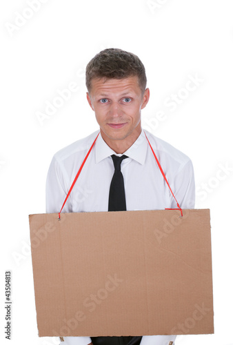 Businessman with an empty cardboard sign on his chest photo