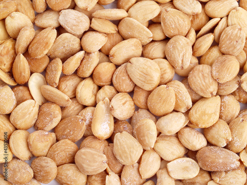 Close up of fried, peeled and salted  almonds.