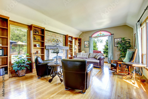 Large living room with firepalce and hardwood floor.