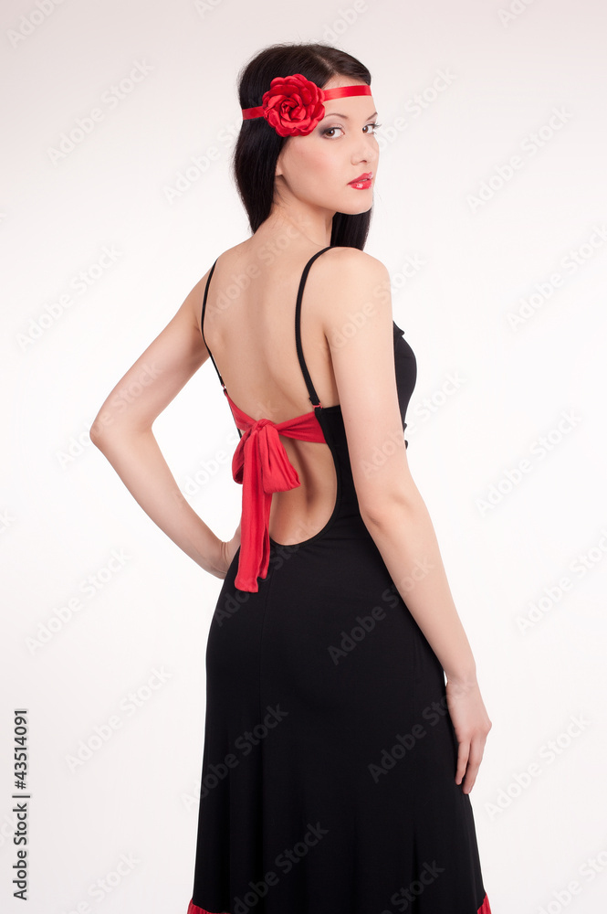 Beautiful young woman wearing a sexy black evening dress Beautiful young woman wearing a sexy black evening dress