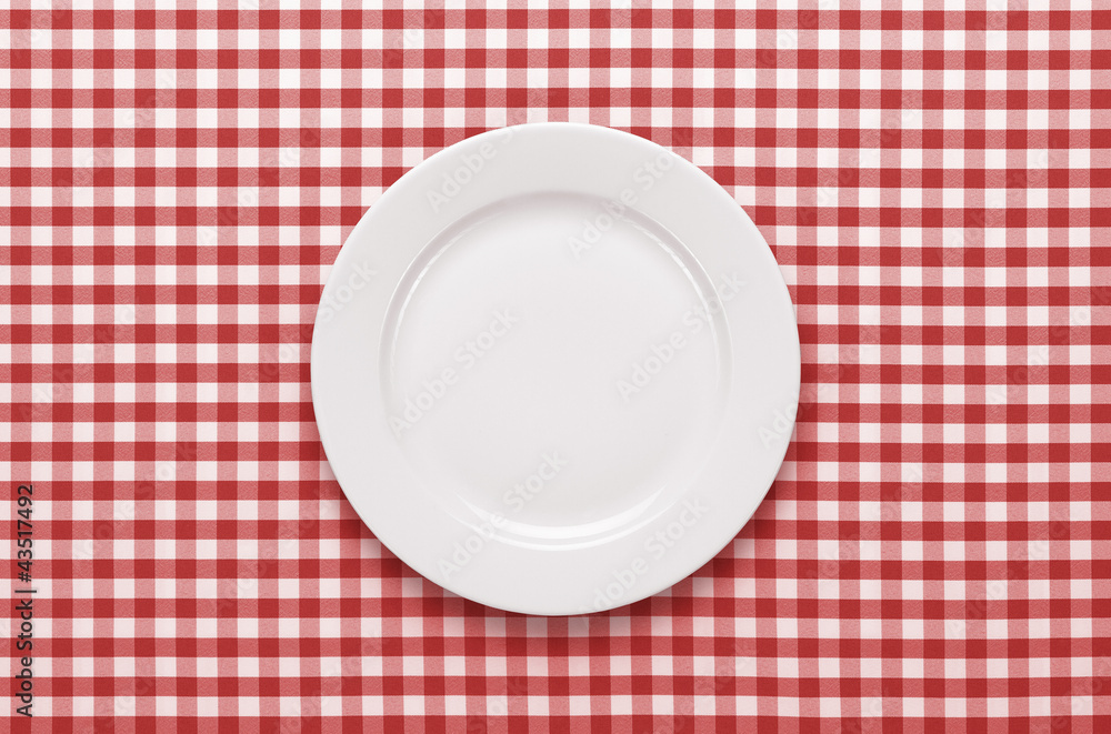 Empty plate at classic checkered tablecloth Empty plate at classic checkered tablecloth