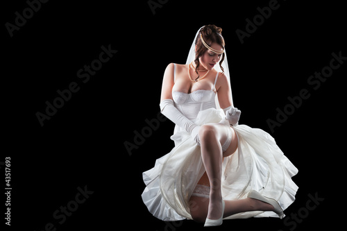 Lovely sensual bride in modern lingerie on black background