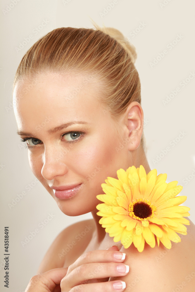 A young woman with a yellow flower, isolated on white A young woman with a yellow flower, isolated on white