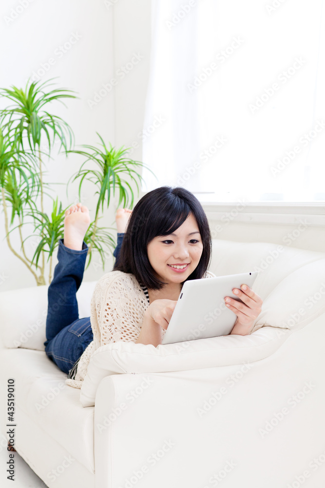 a young asian woman using tablet computer