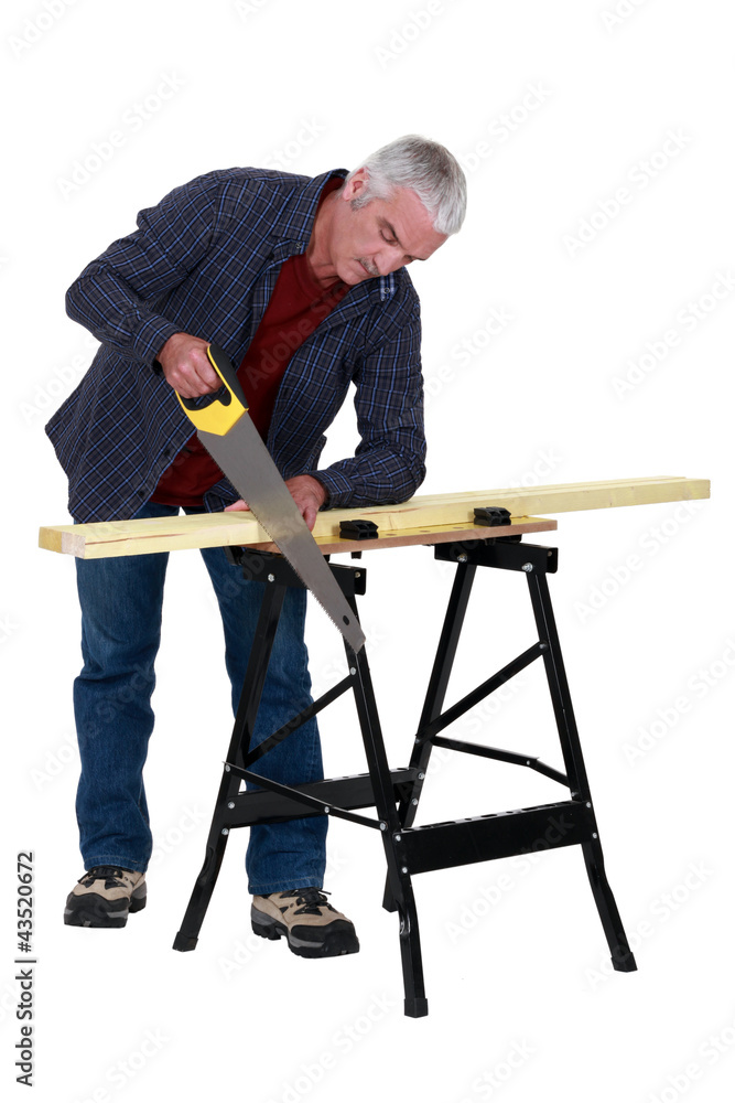 Carpenter sawing wood