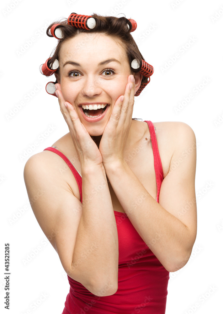 Woman is holding her face in astonishment Woman is holding her face in astonishment
