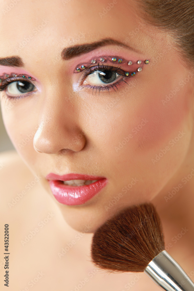 Beautiful young adult woman holds the make-up brushes Beautiful young adult woman holds the make-up brushes