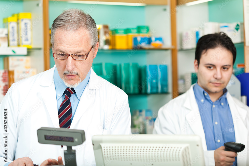 Fototapeta premium Two pharmacists in their store