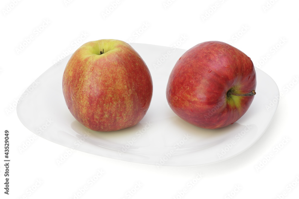 Two red apples on plate. Two red apples on plate.