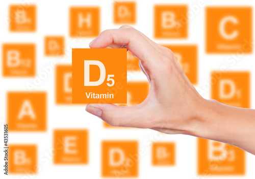 Hand holds a box of vitamin D5 photo