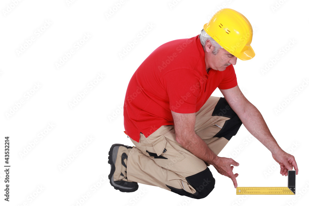 Middle-aged carpenter using set-square Middle-aged carpenter using set-square