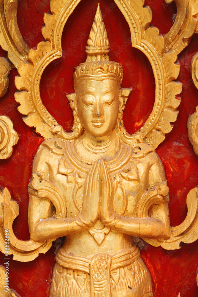 Carving on wooden door of Thai temple