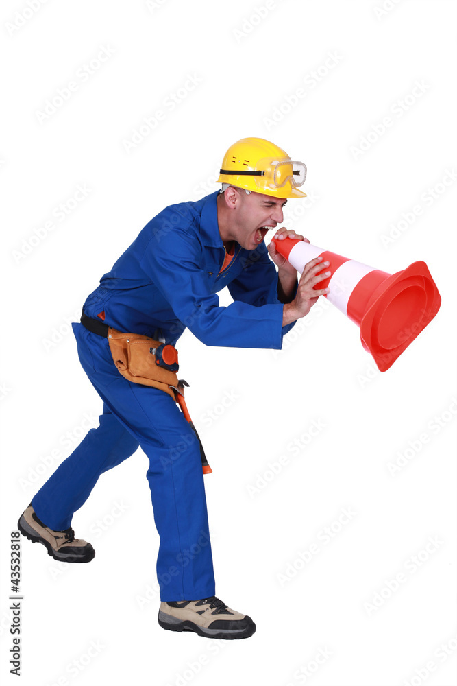 Construction worker shouting into a traffic cone Construction worker shouting into a traffic cone