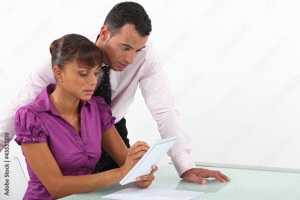 Two businesspeople writing down ideas Two businesspeople writing down ideas