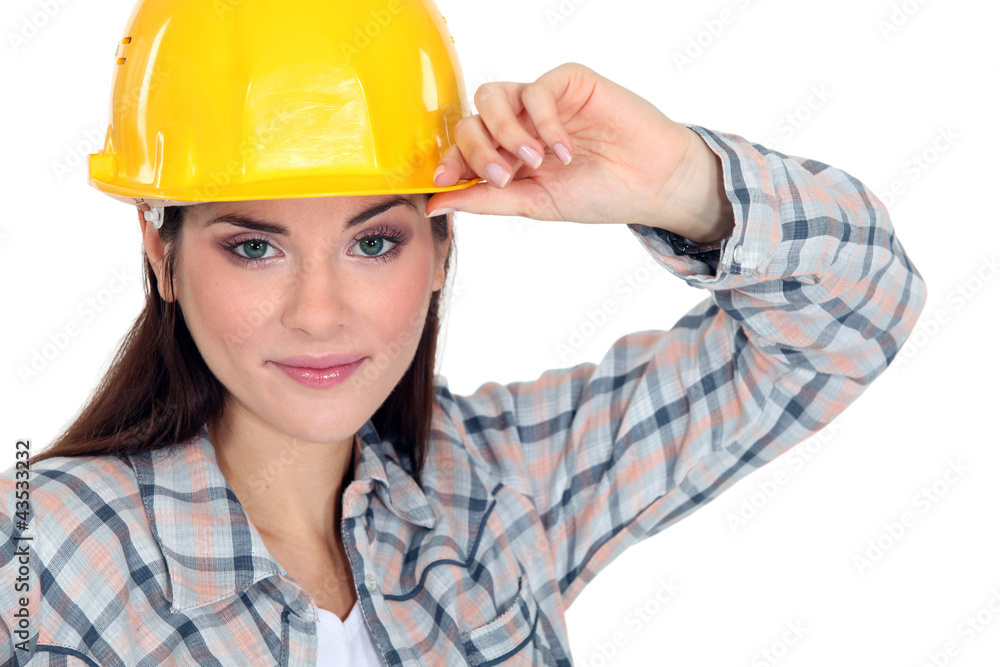 Woman touching the brim of her hard hat Woman touching the brim of her hard hat
