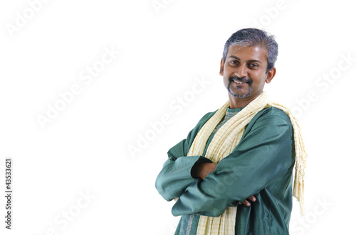 Confident mature traditional Indian man in kurta dhoti isolated