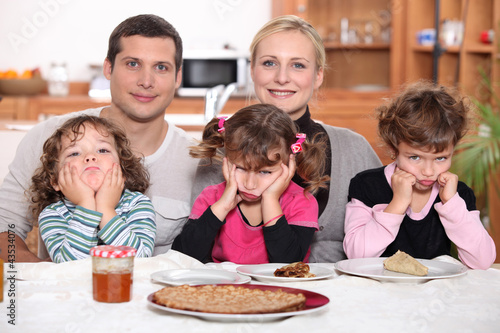 Sulky children with pancakes