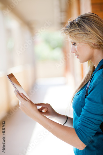 beautiful young blond woman using tablet computer