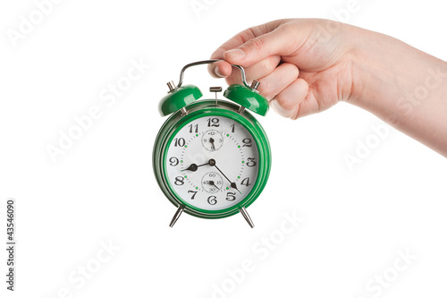 Hand holding alarm clock