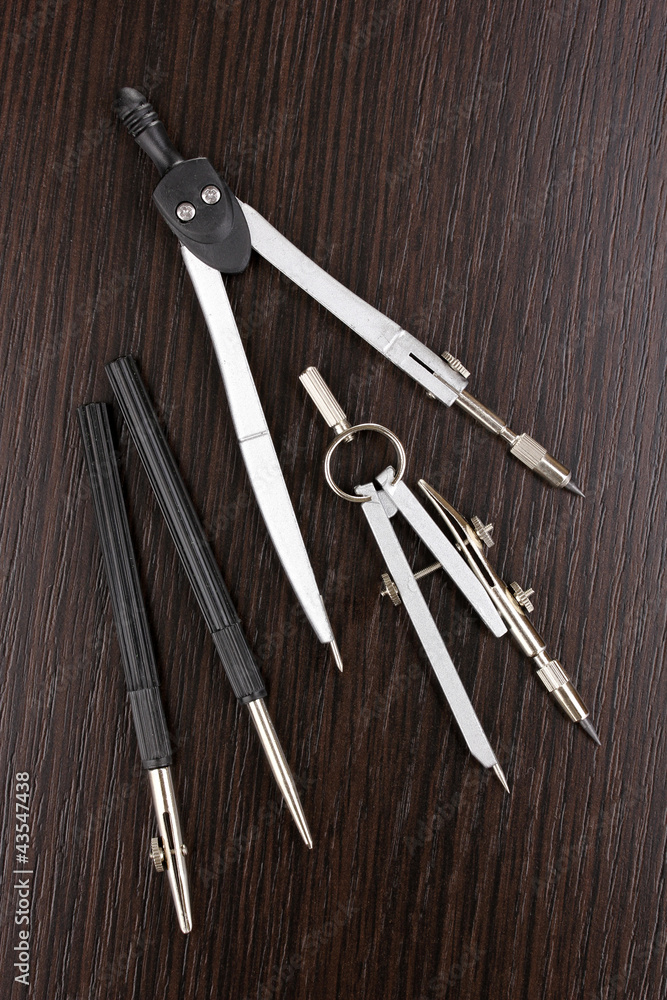 Drafting instruments on wooden background Drafting instruments on wooden background
