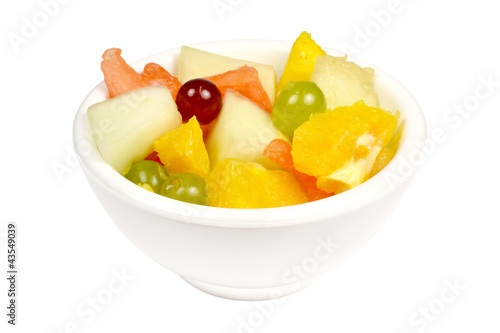Fruit salad in a bowl on a white background.