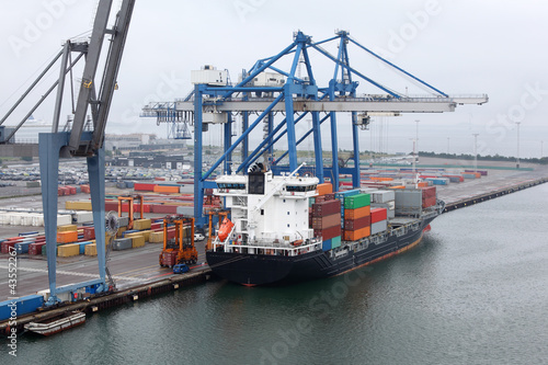 Cargo ship in Copenhagen seaport at misty morning, Denmark;