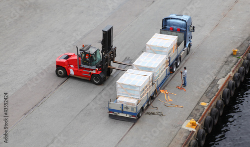 Small auto-loader unload truck, labourer help, view from above