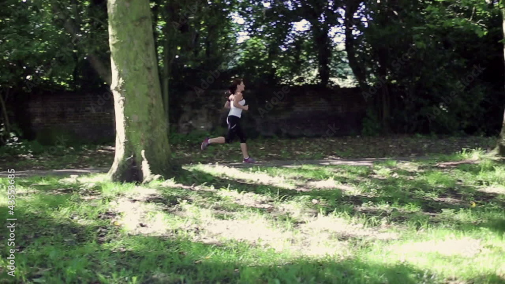 Woman jogging in the park, slow motion Woman jogging in the park, slow motion